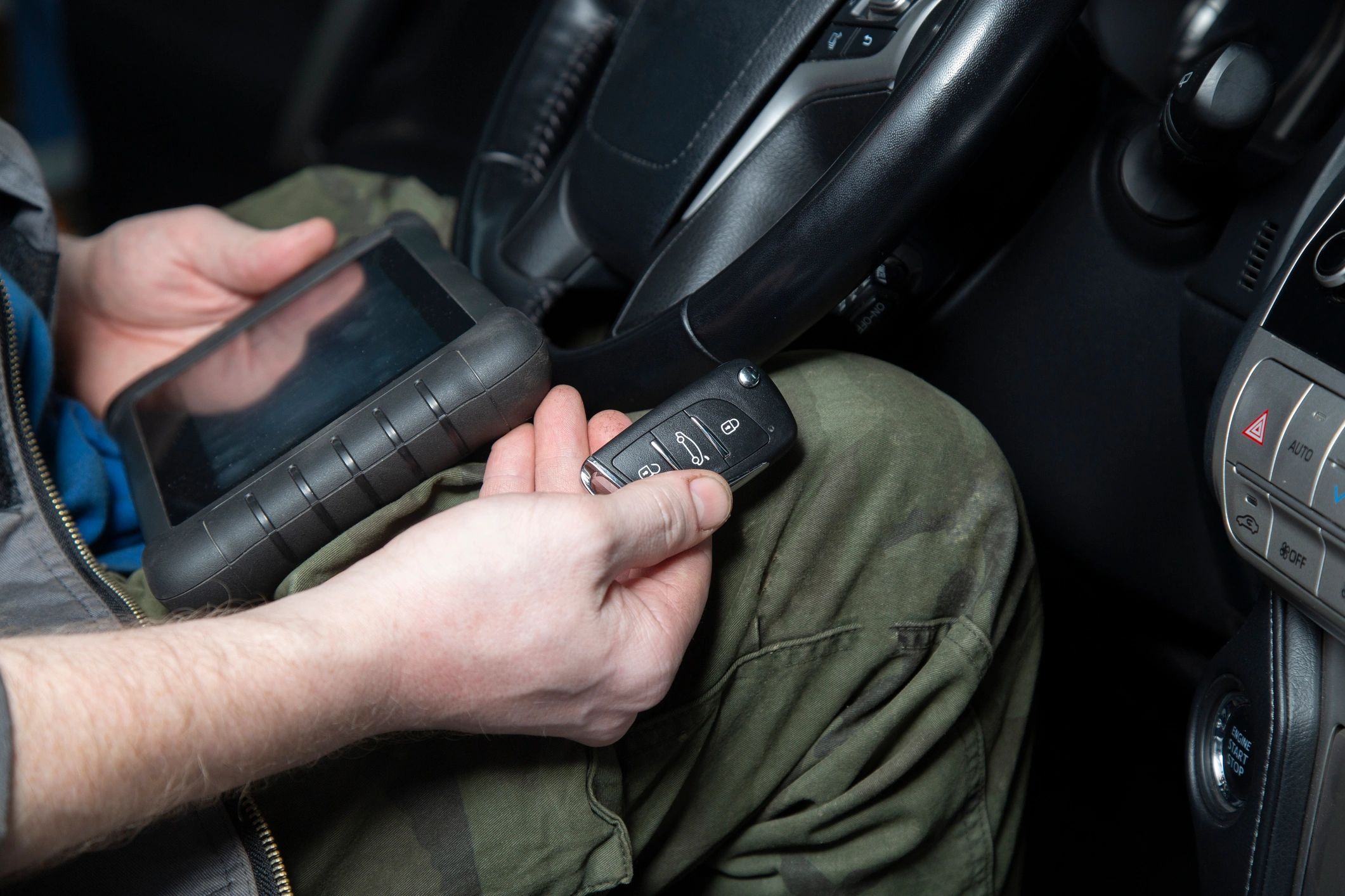 Professional automotive key programming equipment being used on a vehicle