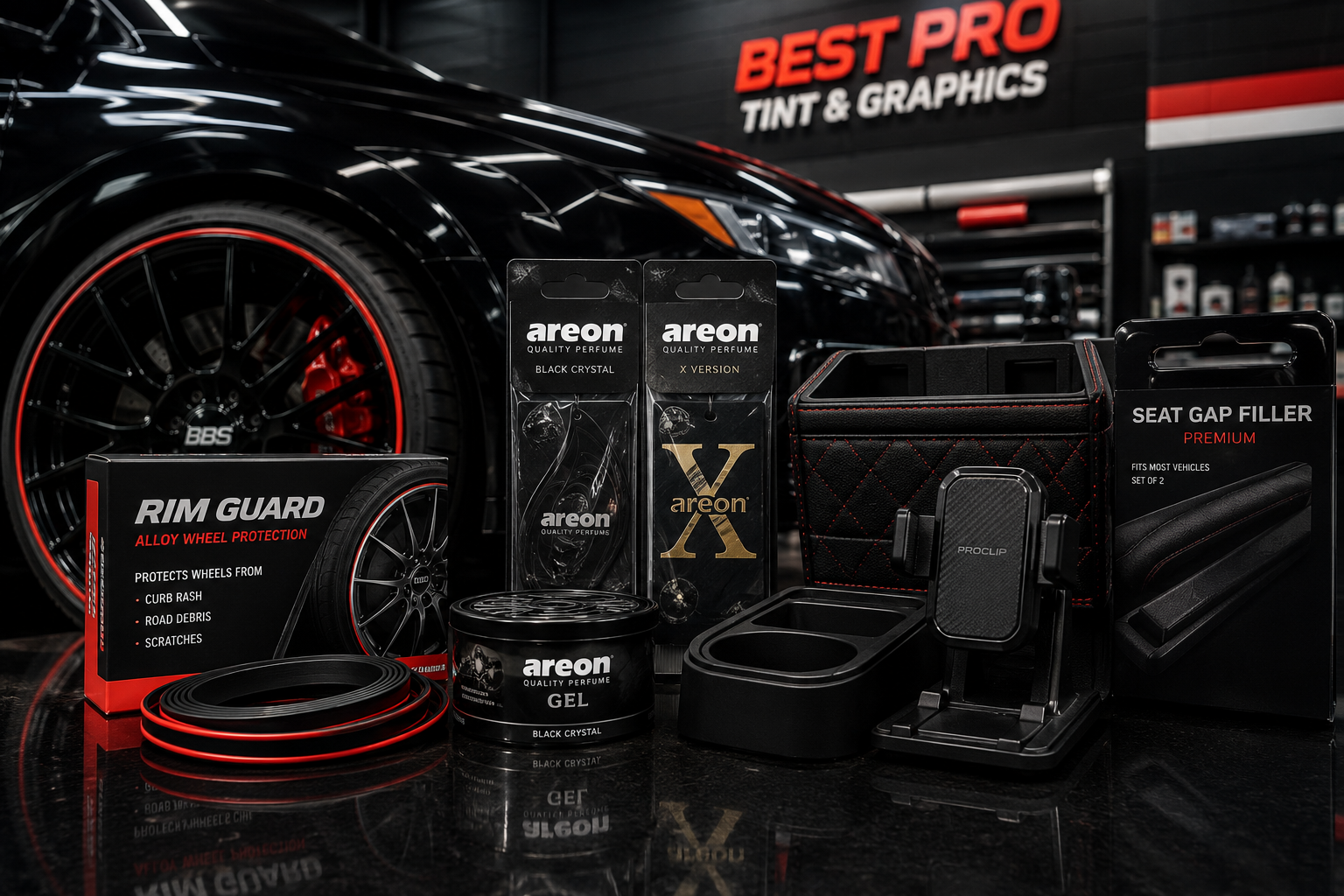 Automotive accessories displayed in front of a premium vehicle wheel inside the Best Pro Tint & Graphics shop