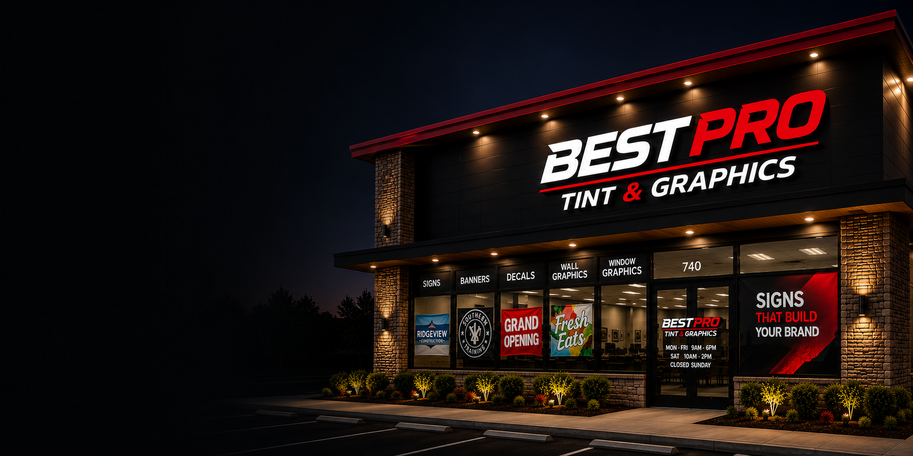 Best Pro Tint & Graphics storefront at night with illuminated signage and window graphics